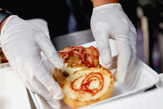 Gloved hands making a sandwich