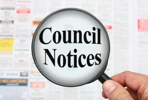 Newspaper  with magnifying glass highlighting Council Notices