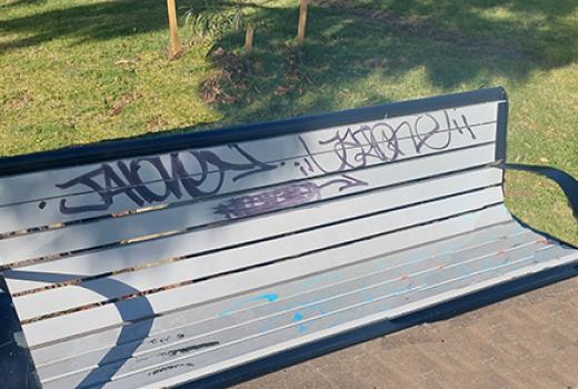 Park bench with graffiti