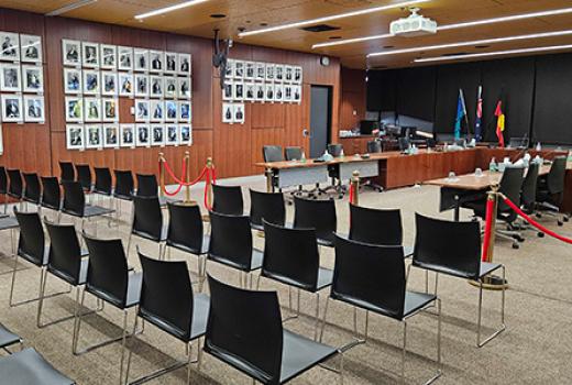 Council chamber with empty chairs for audience