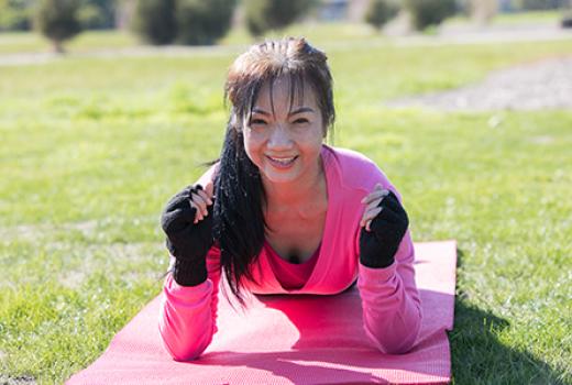 Woman exercising on yoga mat outside